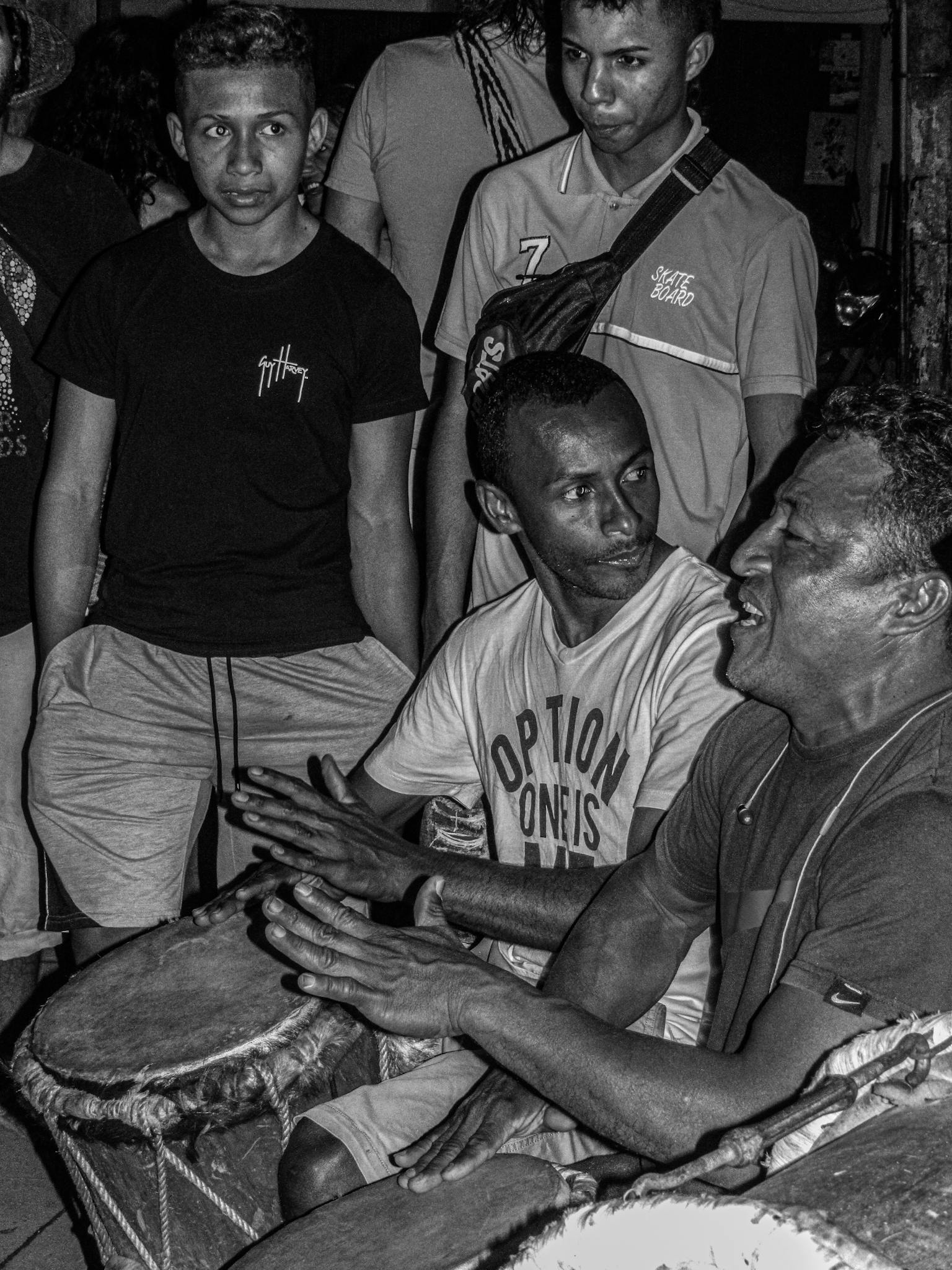 Group of musicians playing drums in a lively cultural setting in Minca, Colombia.